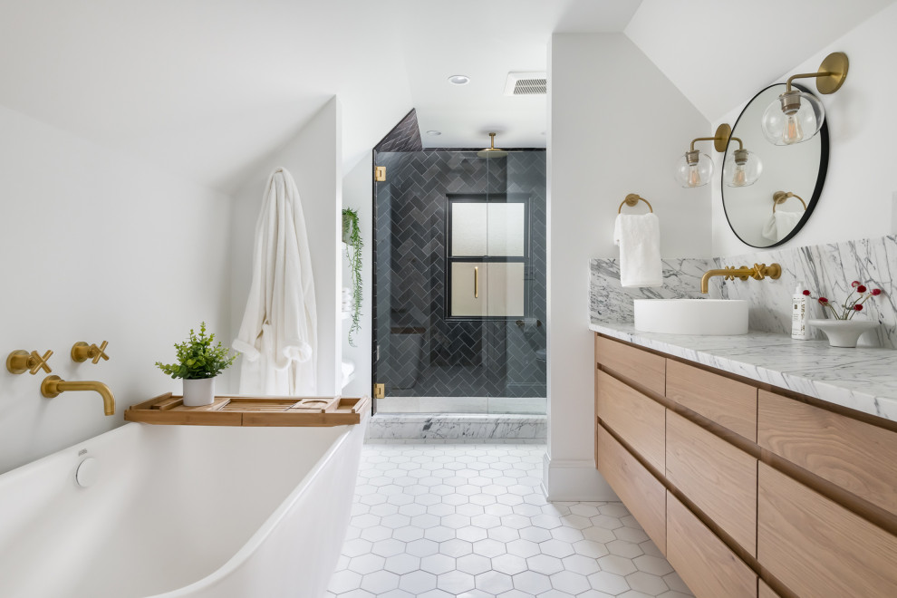 This is an example of a large transitional bathroom in Atlanta with flat-panel cabinets, light wood cabinets, a freestanding tub, an alcove shower, white walls, a vessel sink, marble benchtops, white floor, a hinged shower door, a double vanity and a built-in vanity.