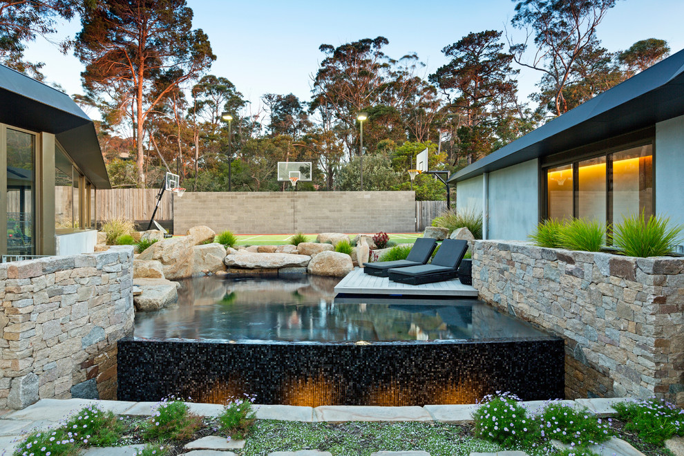 Large contemporary backyard pool in Melbourne.