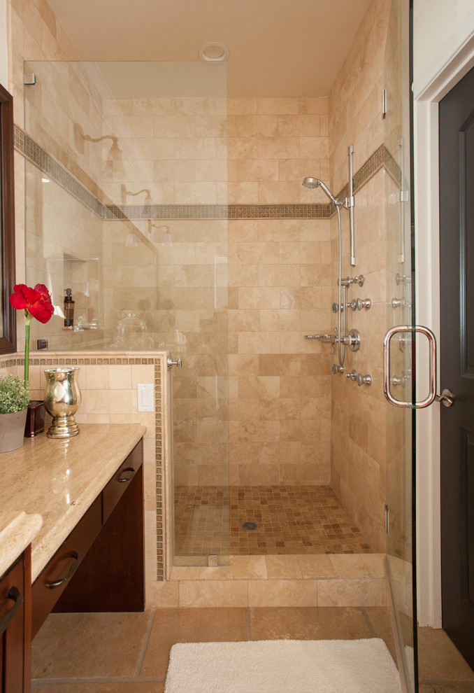 Design ideas for a large mediterranean master bathroom in Los Angeles with recessed-panel cabinets, dark wood cabinets, an undermount tub, a double shower, a bidet, beige tile, travertine, beige walls, travertine floors, an undermount sink, limestone benchtops and a hinged shower door.