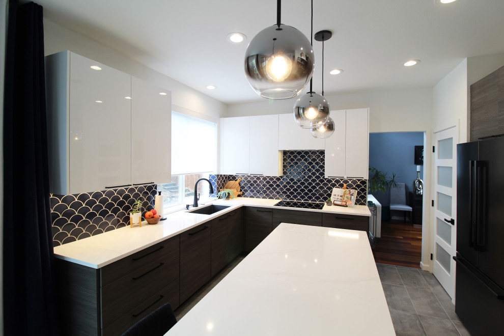 Photo of a mid-sized modern l-shaped open plan kitchen in Seattle with an undermount sink, flat-panel cabinets, dark wood cabinets, quartz benchtops, blue splashback, mosaic tile splashback, black appliances, ceramic floors, with island, grey floor and white benchtop.