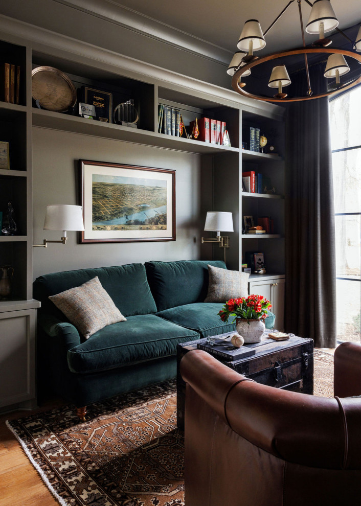 French country medium tone wood floor and brown floor family room photo in Houston with gray walls