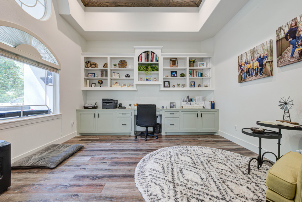 Inspiration for a large country study room in Houston with white walls, vinyl floors, no fireplace, a built-in desk, brown floor and coffered.