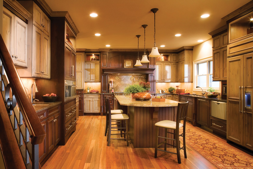 Inspiration for a large eclectic u-shaped eat-in kitchen in Minneapolis with an undermount sink, flat-panel cabinets, distressed cabinets, granite benchtops, brown splashback, stainless steel appliances, medium hardwood floors and with island.