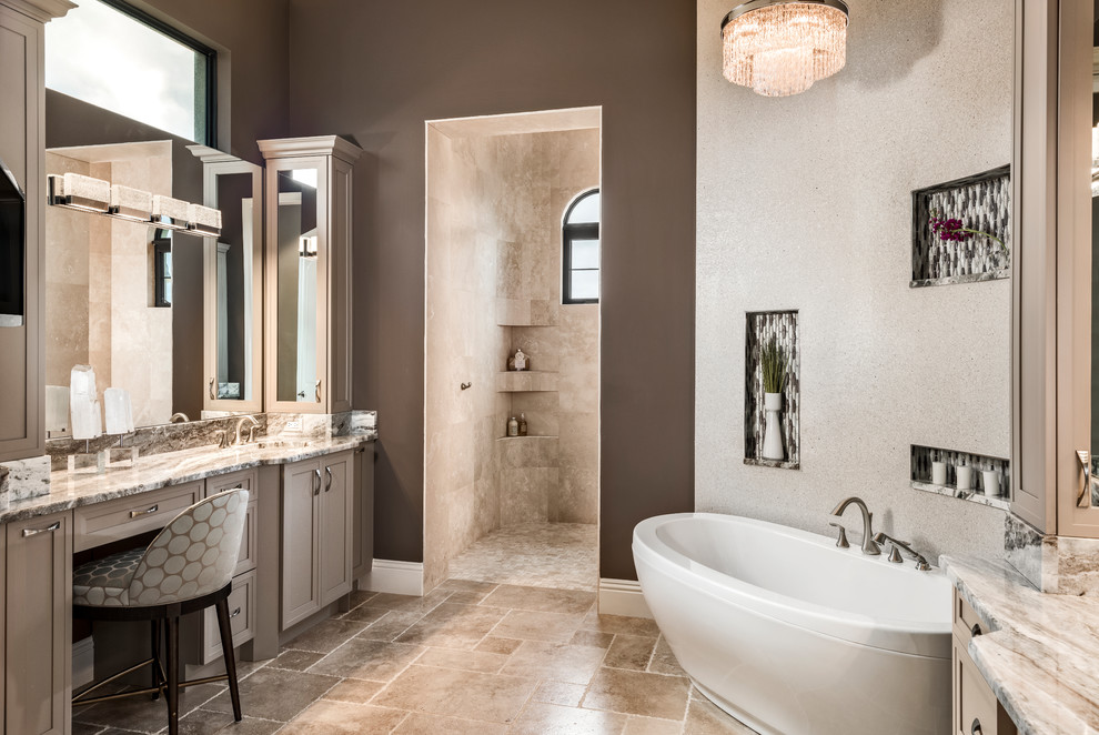 Inspiration for a mid-sized transitional master bathroom in Miami with a freestanding tub, brown walls, porcelain floors, marble benchtops, shaker cabinets, brown cabinets, beige tile, beige floor and multi-coloured benchtops.