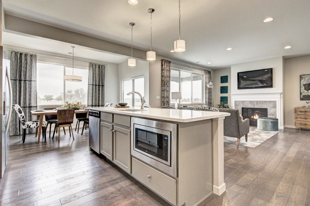 This is an example of a contemporary eat-in kitchen in Denver with shaker cabinets, grey cabinets, quartzite benchtops, white splashback, subway tile splashback, stainless steel appliances and with island.