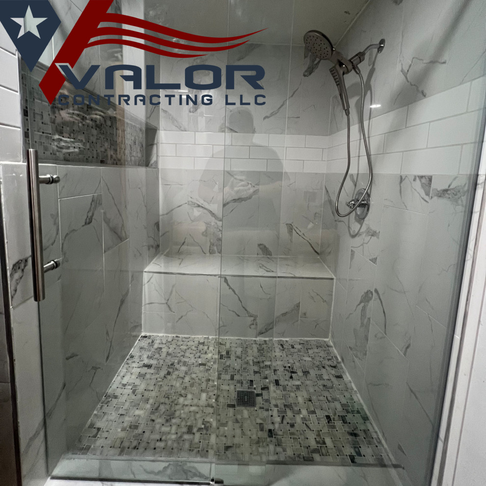 Example of a large minimalist master white tile and porcelain tile vinyl floor, multicolored floor and single-sink doorless shower design in Houston with raised-panel cabinets, dark wood cabinets, a two-piece toilet, white walls, an undermount sink, quartzite countertops, white countertops, a niche and a built-in vanity