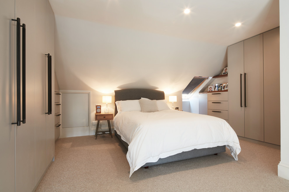 Photo of a large contemporary master bedroom in London with white walls, carpet, no fireplace and beige floor.
