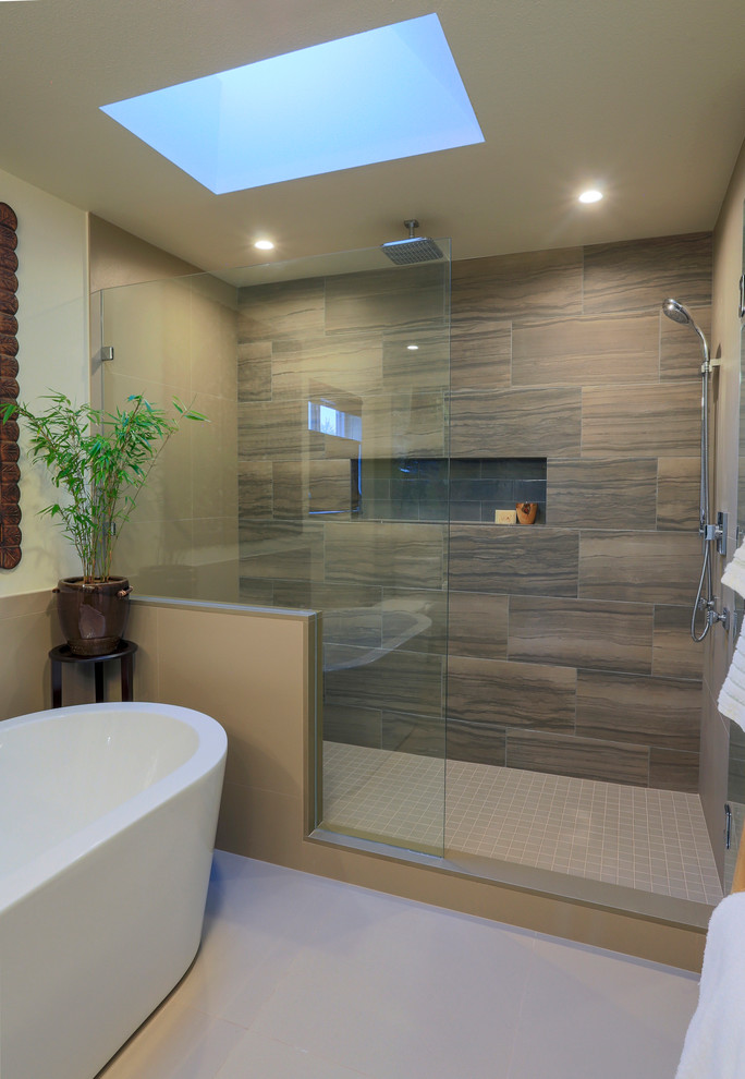 Photo of a mid-sized asian master bathroom in Seattle with flat-panel cabinets, dark wood cabinets, a freestanding tub, a double shower, a two-piece toilet, beige tile, porcelain tile, beige walls, porcelain floors, an undermount sink and granite benchtops.