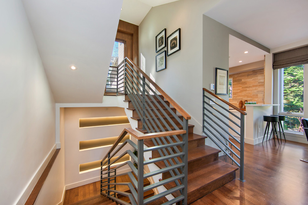 Inspiration for a contemporary wood u-shaped staircase in San Francisco with wood risers.