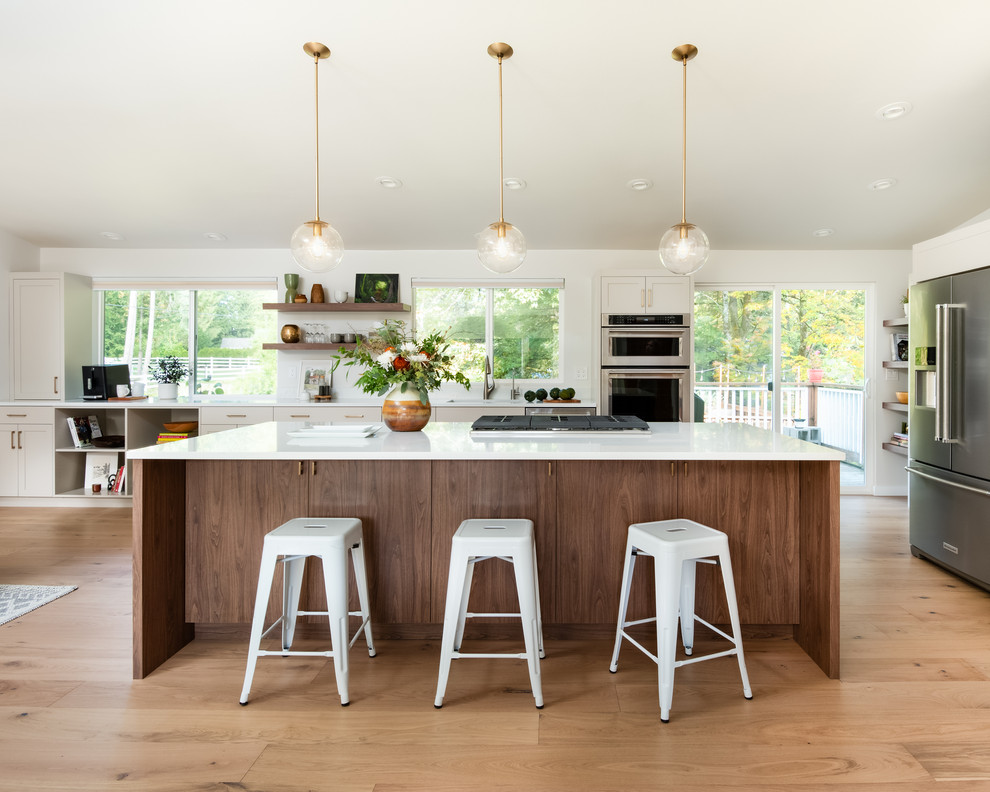 Mid-sized contemporary kitchen in Seattle with shaker cabinets, stainless steel appliances, with island, white benchtop, an undermount sink, beige cabinets, light hardwood floors and window splashback.