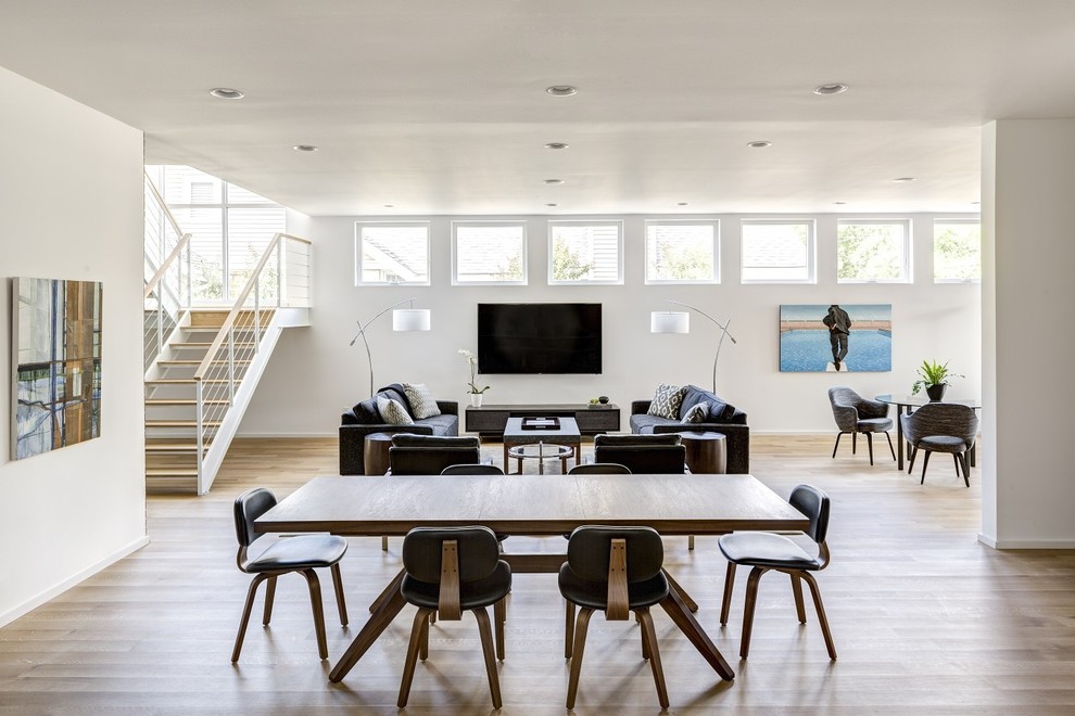 Photo of a mid-sized contemporary open plan dining in Little Rock with white walls, light hardwood floors and no fireplace.