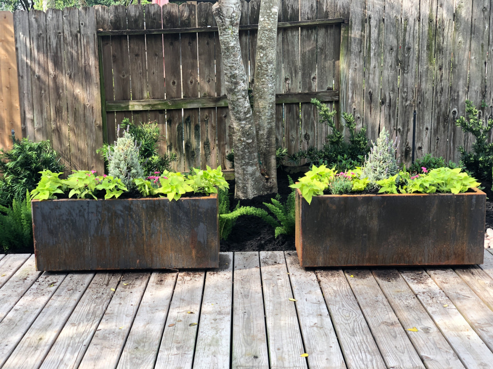 Large country backyard partial sun garden in Houston with a container garden and decking.
