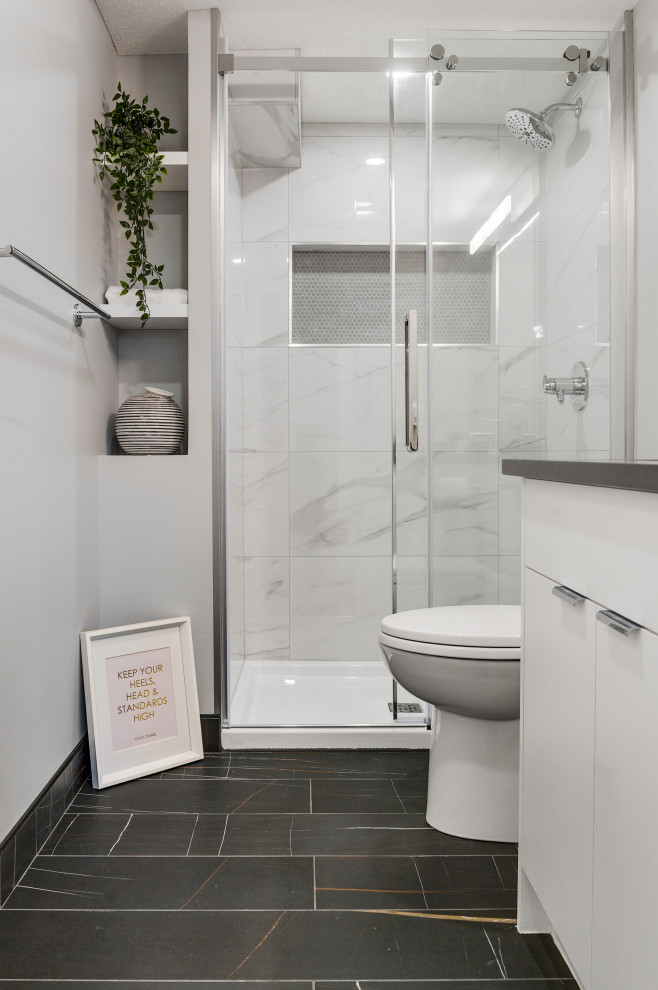Design ideas for a small contemporary bathroom in Calgary with white cabinets, an alcove shower, a two-piece toilet, black and white tile, porcelain tile, grey walls, porcelain floors, an undermount sink, engineered quartz benchtops, black floor, a sliding shower screen, grey benchtops, a niche, a single vanity and a built-in vanity.