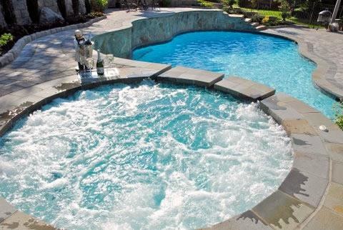 Large backyard stone and custom-shaped natural pool fountain photo in Baltimore
