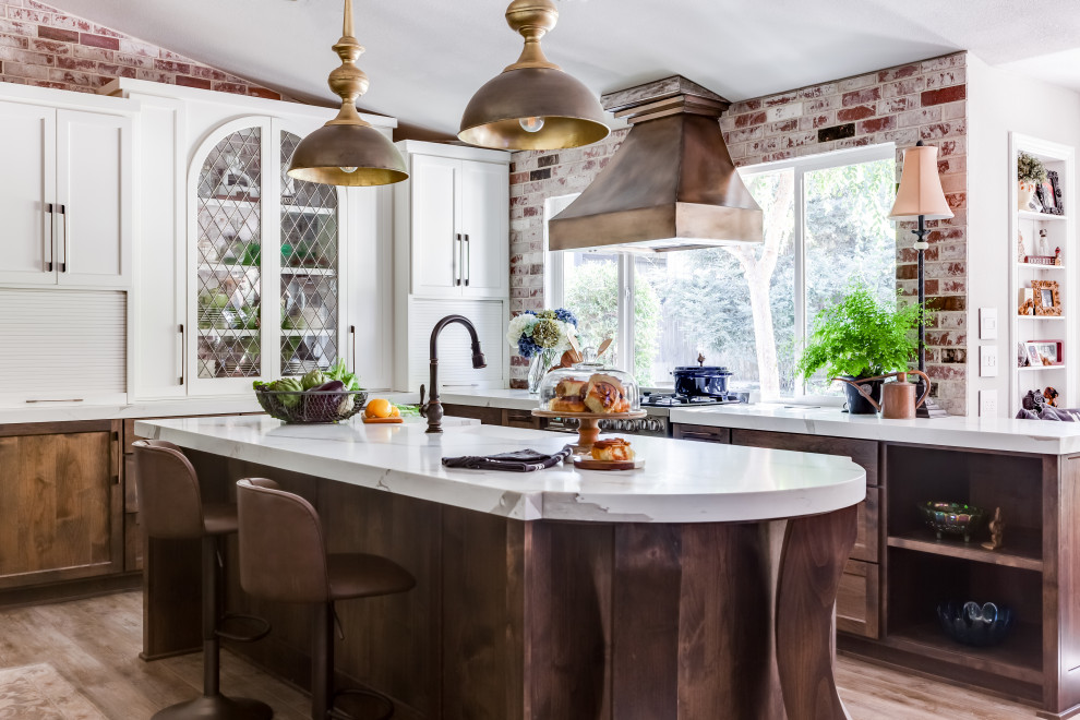 Design ideas for a mid-sized traditional u-shaped open plan kitchen in Sacramento with a farmhouse sink, shaker cabinets, medium wood cabinets, quartz benchtops, coloured appliances, vinyl floors, with island, brown floor and white benchtop.