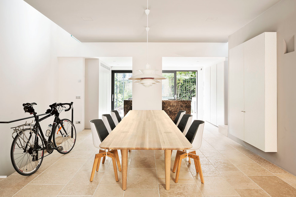 Photo of a large scandinavian dining room in Milan with white walls.