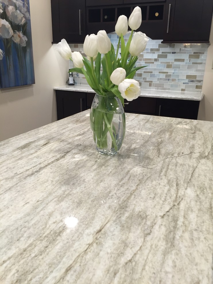 Inspiration for a transitional ceramic tile kitchen remodel with a single-bowl sink, dark wood cabinets, multicolored backsplash, mosaic tile backsplash, stainless steel appliances and an island