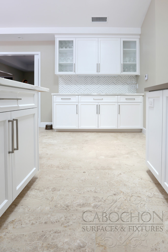 Inspiration for a mid-sized transitional l-shaped limestone floor open concept kitchen remodel in San Diego with an island, shaker cabinets, white cabinets, marble countertops, white backsplash, mosaic tile backsplash, stainless steel appliances, an undermount sink and beige walls