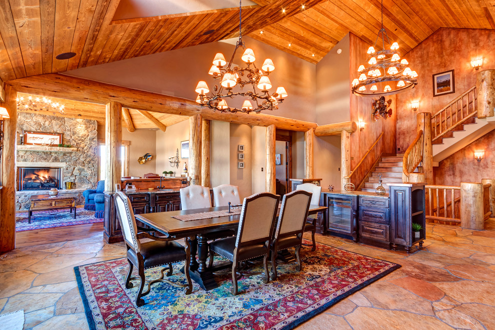 Example of a large mountain style medium tone wood floor and brown floor kitchen/dining room combo design with brown walls and no fireplace