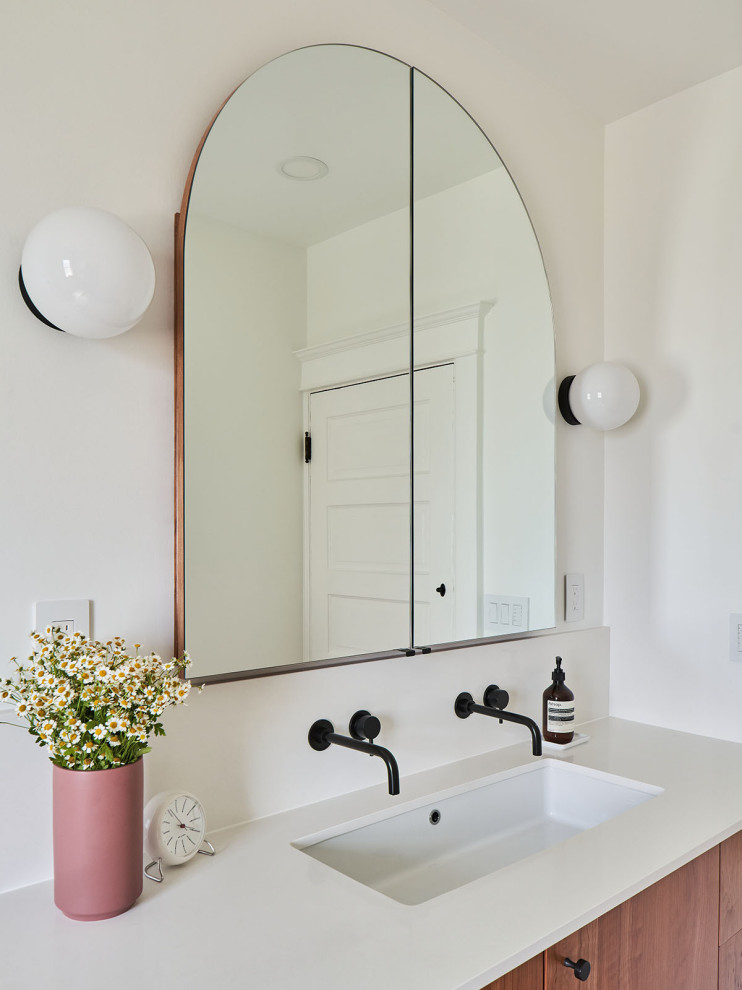 Mid-sized midcentury bathroom in Portland with flat-panel cabinets, medium wood cabinets, an alcove shower, a one-piece toilet, white tile, ceramic tile, white walls, porcelain floors, a trough sink, engineered quartz benchtops, grey floor, a shower curtain, white benchtops, a niche, a single vanity and a built-in vanity.