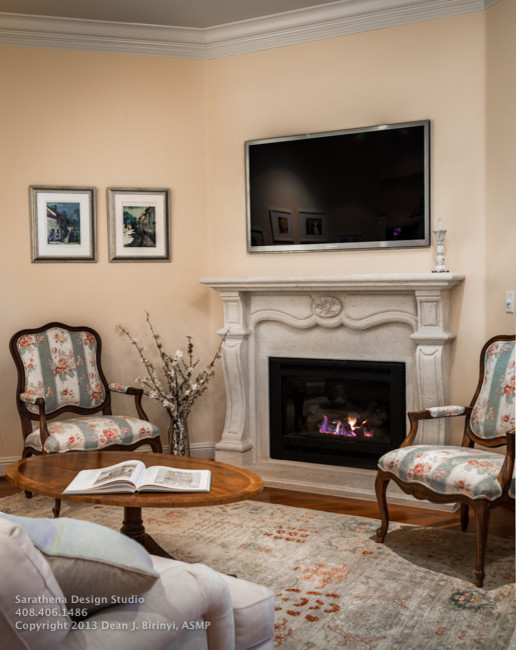 Inspiration for a mid-sized traditional open concept family room in San Francisco with a wall-mounted tv, yellow walls, medium hardwood floors, a standard fireplace and a stone fireplace surround.