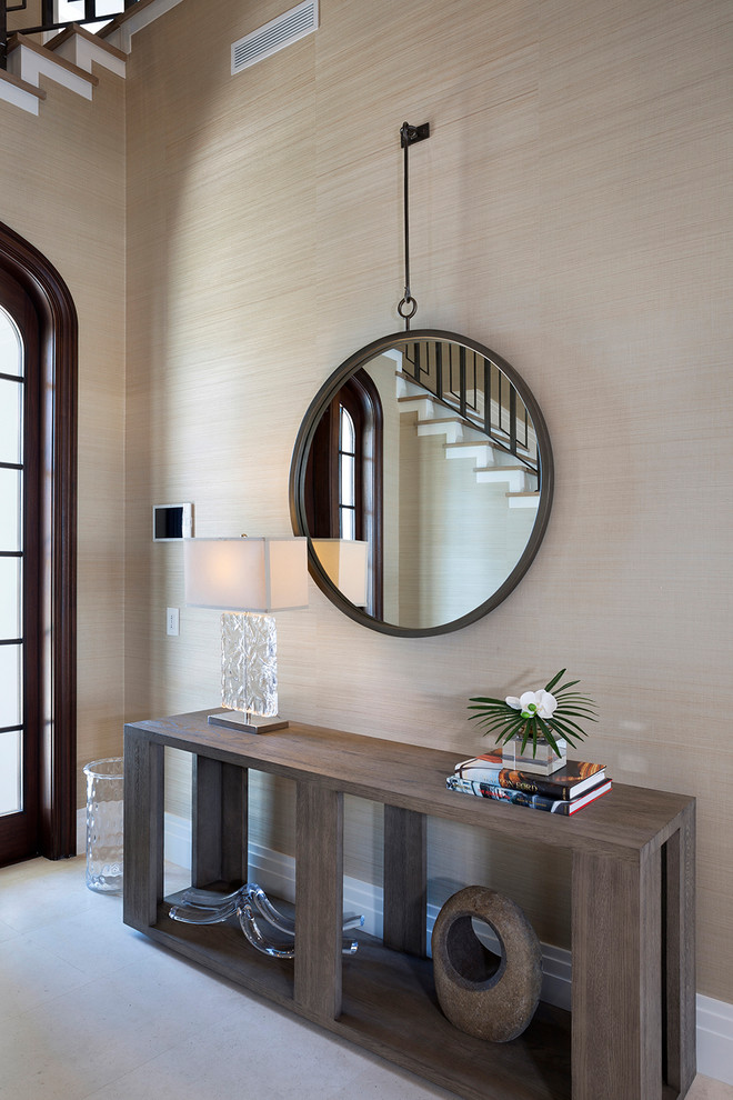 This is an example of a large contemporary hallway in Miami with beige walls and concrete floors.