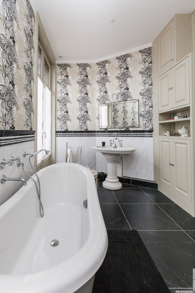 This is an example of a mid-sized traditional master bathroom in Toulouse with flat-panel cabinets, grey cabinets, a claw-foot tub, white tile, ceramic tile, white walls, marble floors and a pedestal sink.