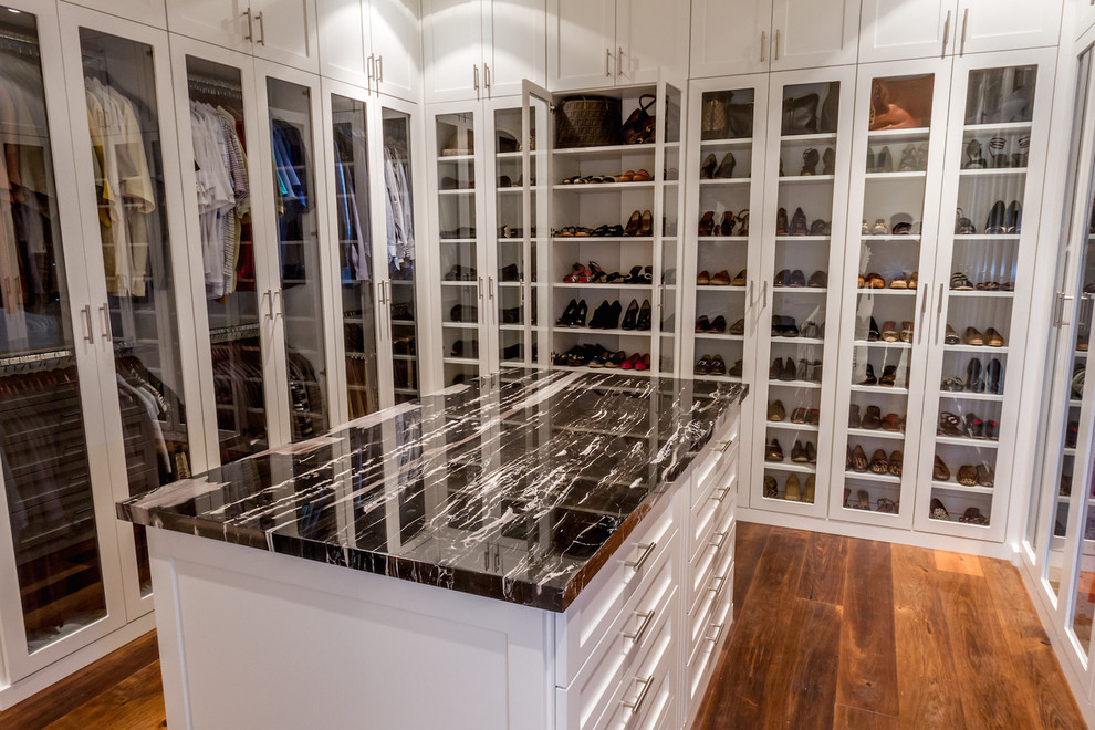 Inspiration for a large transitional gender-neutral walk-in wardrobe in Los Angeles with recessed-panel cabinets, white cabinets and medium hardwood floors.