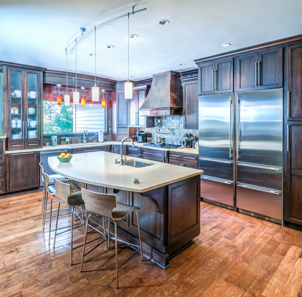 This is an example of an eclectic u-shaped eat-in kitchen in Indianapolis with an undermount sink, shaker cabinets, dark wood cabinets, quartz benchtops and stainless steel appliances.