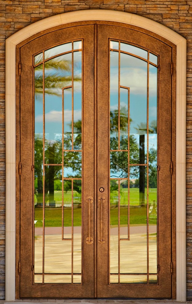 Photo of a large contemporary front door in Miami with a double front door and a metal front door.