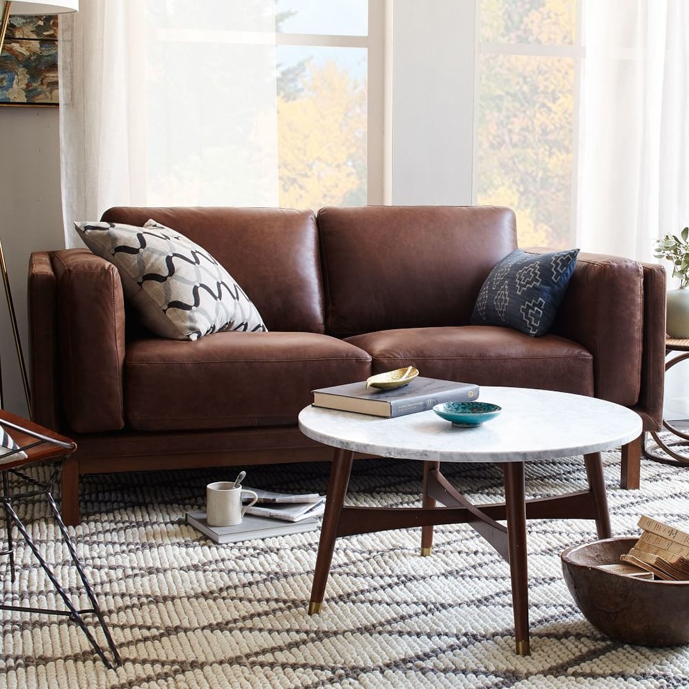 This is an example of a mid-sized eclectic enclosed living room in London with beige walls, carpet, no fireplace and no tv.