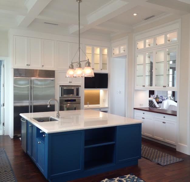 Inspiration for a mid-sized transitional dark wood floor and brown floor kitchen remodel in Miami with a single-bowl sink, shaker cabinets, white cabinets, granite countertops, stainless steel appliances and an island