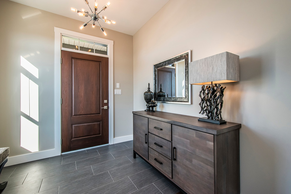 Inspiration for a mid-sized transitional porcelain tile foyer remodel with beige walls and a dark wood front door