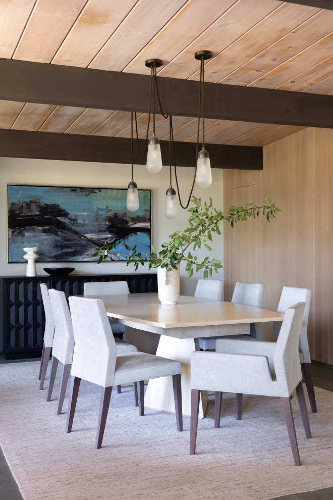 This is an example of a medium sized midcentury dining room in San Francisco with beige walls, slate flooring, green floors, exposed beams and panelled walls.