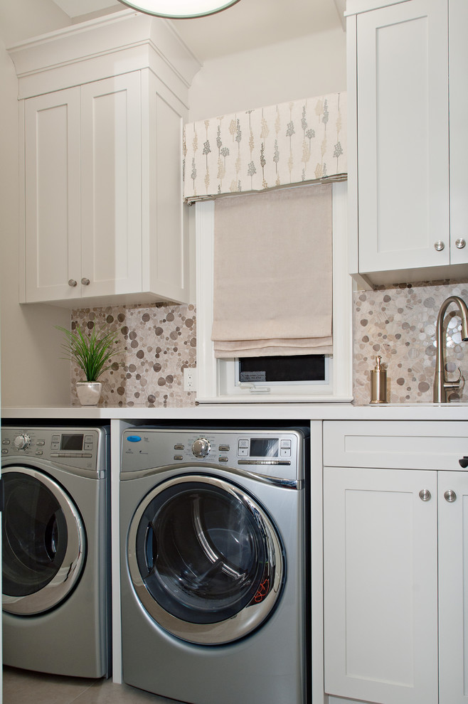 Photo of a mid-sized transitional galley dedicated laundry room in Toronto with white cabinets, white walls, an undermount sink, quartz benchtops, a side-by-side washer and dryer, white benchtop and shaker cabinets.