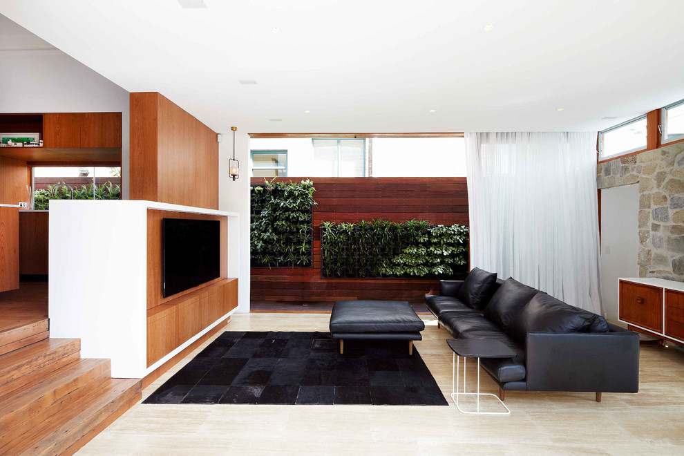 Design ideas for a large modern living room in Sydney with a wall-mounted tv, white walls and travertine floors.