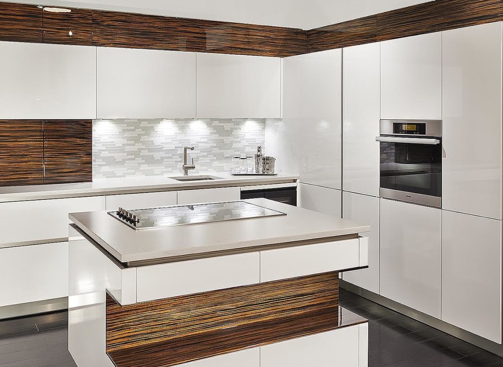 Inspiration for a mid-sized modern l-shaped separate kitchen in Miami with an undermount sink, flat-panel cabinets, white cabinets, quartzite benchtops, grey splashback, matchstick tile splashback, laminate floors, with island and black floor.