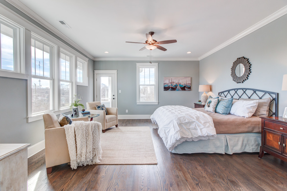 Large transitional master bedroom in Raleigh with grey walls and dark hardwood floors.