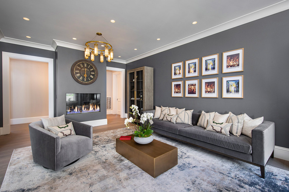 Photo of a large contemporary open concept family room in San Francisco with grey walls, medium hardwood floors, a wood stove, a plaster fireplace surround and brown floor.