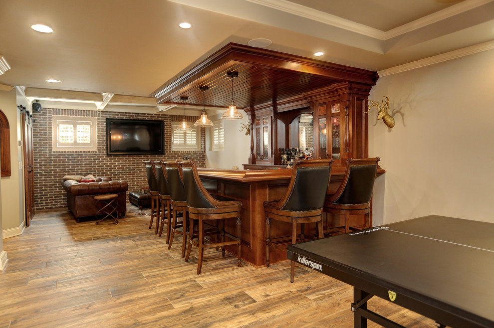 Mid-sized l-shaped seated home bar in Atlanta with an undermount sink, flat-panel cabinets, brown cabinets, granite benchtops, porcelain floors, brown floor and mirror splashback.