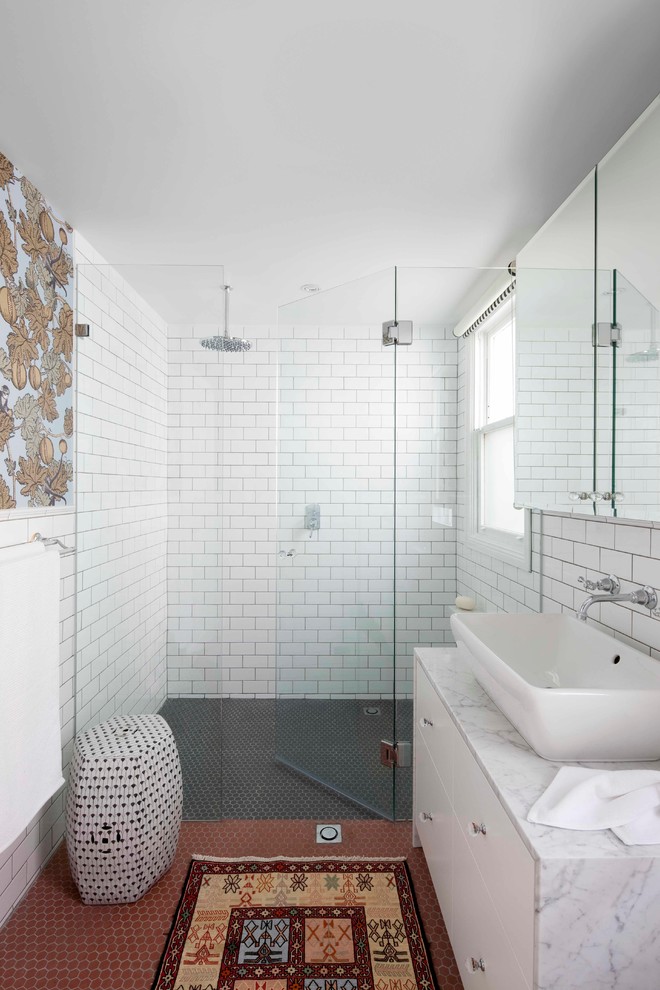 Inspiration for a mid-sized transitional bathroom in Sydney with a vessel sink, flat-panel cabinets, white cabinets, marble benchtops, white tile, subway tile, white walls, a curbless shower, mosaic tile floors and red floor.