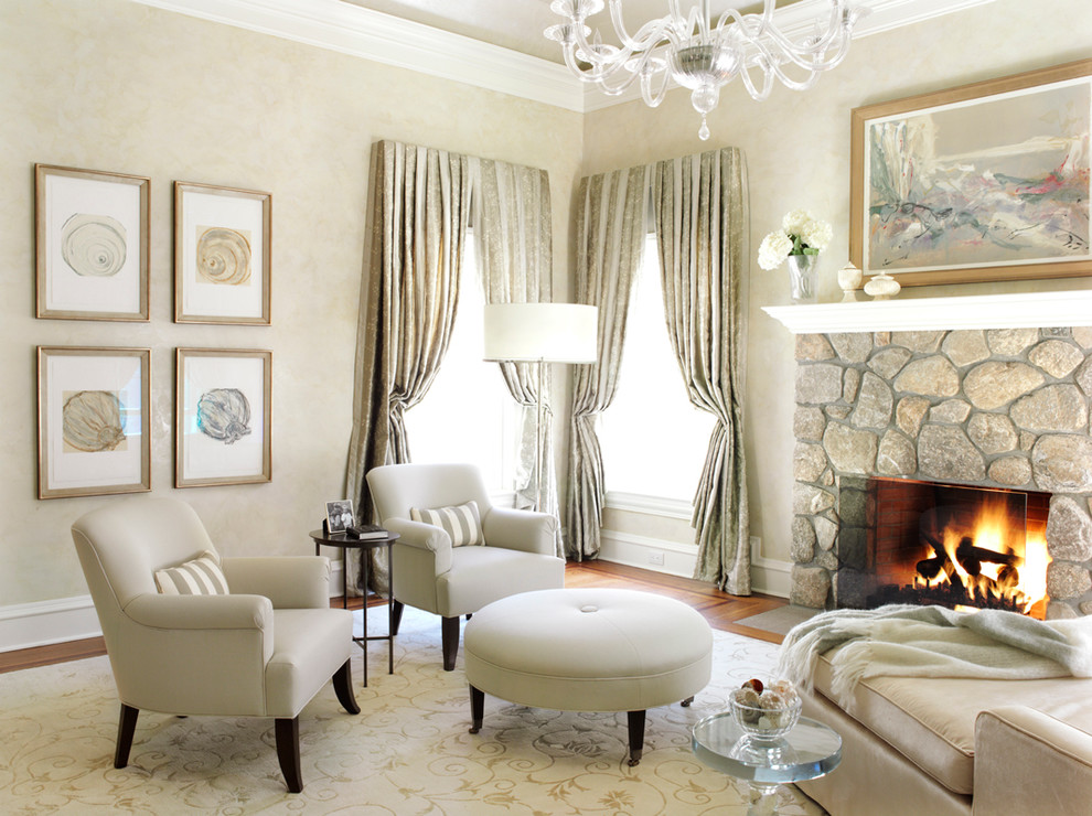 Inspiration for a transitional bedroom in New York with beige walls, medium hardwood floors, a standard fireplace and a stone fireplace surround.