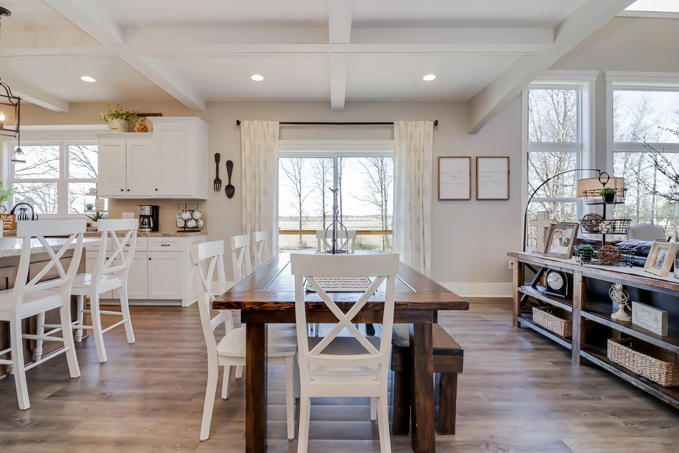 This is an example of a mid-sized country open plan dining in Grand Rapids with beige walls, medium hardwood floors, brown floor and no fireplace.