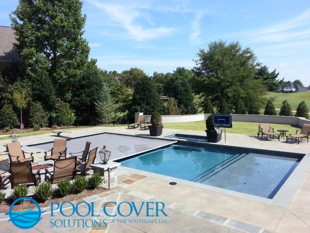 This is an example of a large traditional backyard rectangular pool in Charleston with a hot tub and stamped concrete.