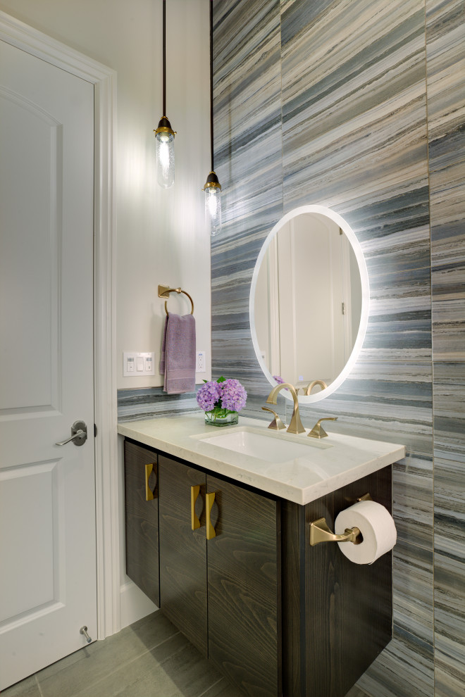 Inspiration for a medium sized classic cloakroom in Sacramento with flat-panel cabinets, brown cabinets, blue tiles, porcelain tiles, beige walls, porcelain flooring, a submerged sink, engineered stone worktops, grey floors, beige worktops, a built in vanity unit and a wall mounted toilet.