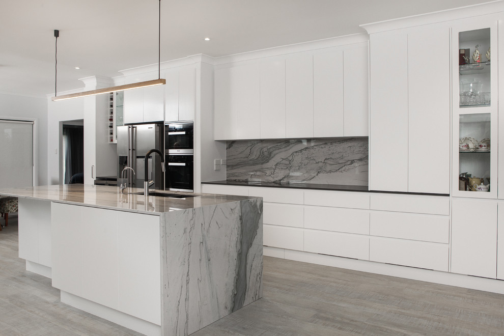 Inspiration for a modern eat-in kitchen in Brisbane with an undermount sink, white cabinets, marble benchtops, grey splashback, marble splashback, stainless steel appliances, vinyl floors, with island, grey floor and grey benchtop.