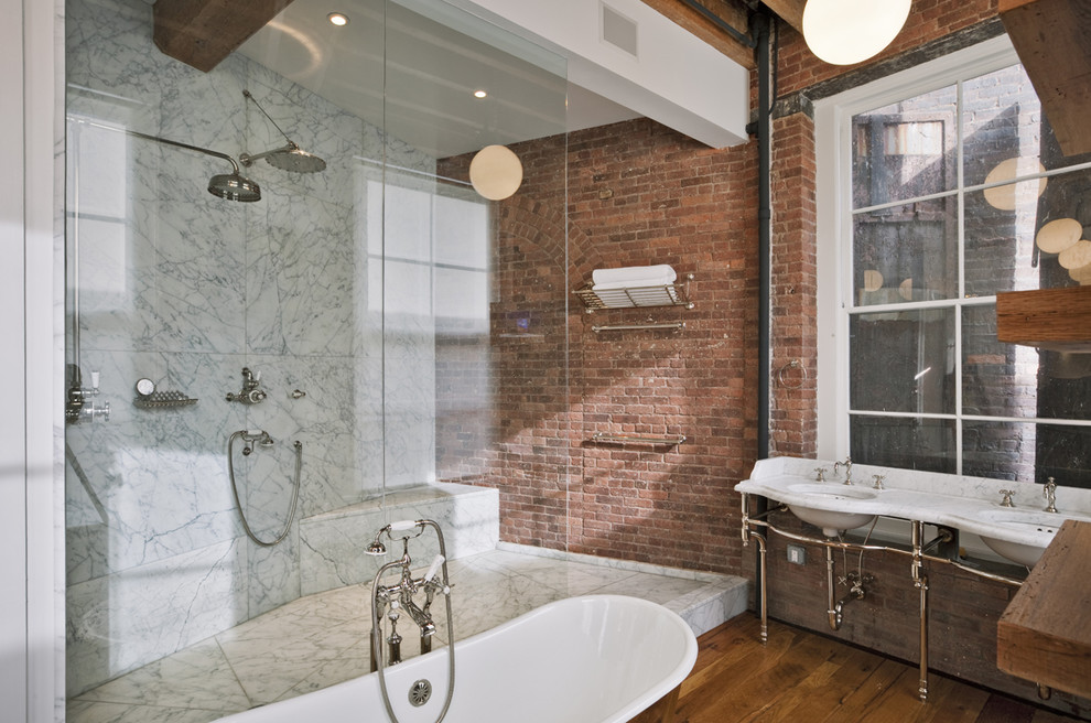 Large industrial master bathroom in New York with white tile, gray tile, a freestanding tub, an alcove shower, marble, red walls, medium hardwood floors, a console sink, marble benchtops, open cabinets, medium wood cabinets, brown floor and an open shower.
