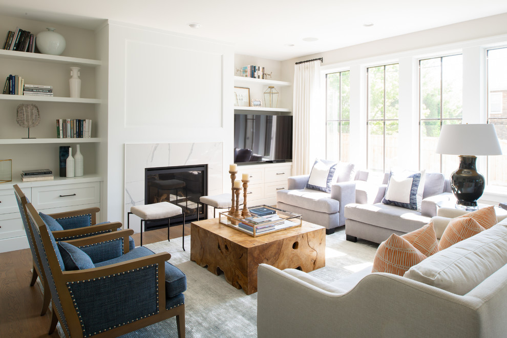 Inspiration for a mid-sized transitional enclosed family room in Minneapolis with white walls, light hardwood floors, a standard fireplace, a stone fireplace surround, a freestanding tv and brown floor.