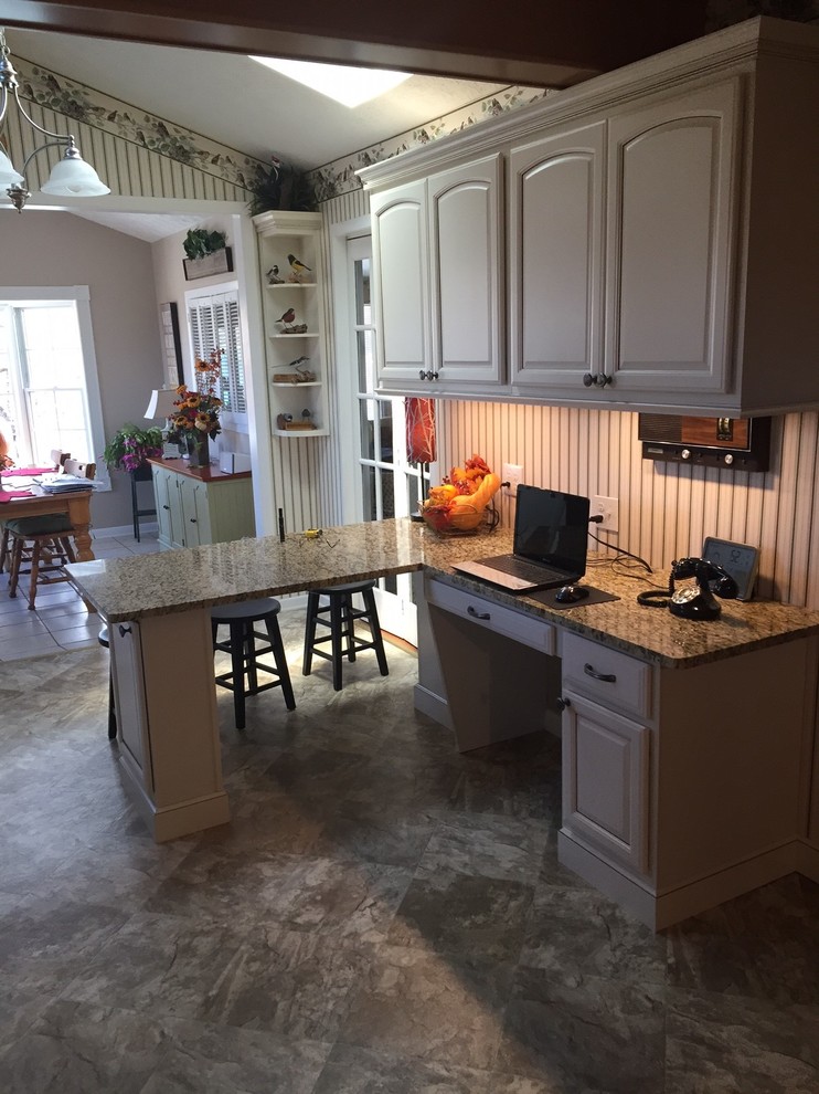 Small transitional l-shaped eat-in kitchen photo with raised-panel cabinets, beige cabinets, granite countertops and a peninsula