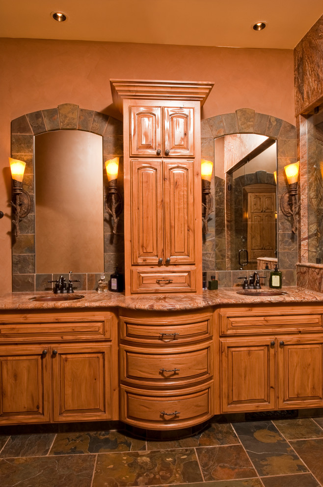 Design ideas for a country master bathroom in Other with an undermount sink, raised-panel cabinets, distressed cabinets, marble benchtops, a one-piece toilet, brown tile, stone tile, brown walls and slate floors.